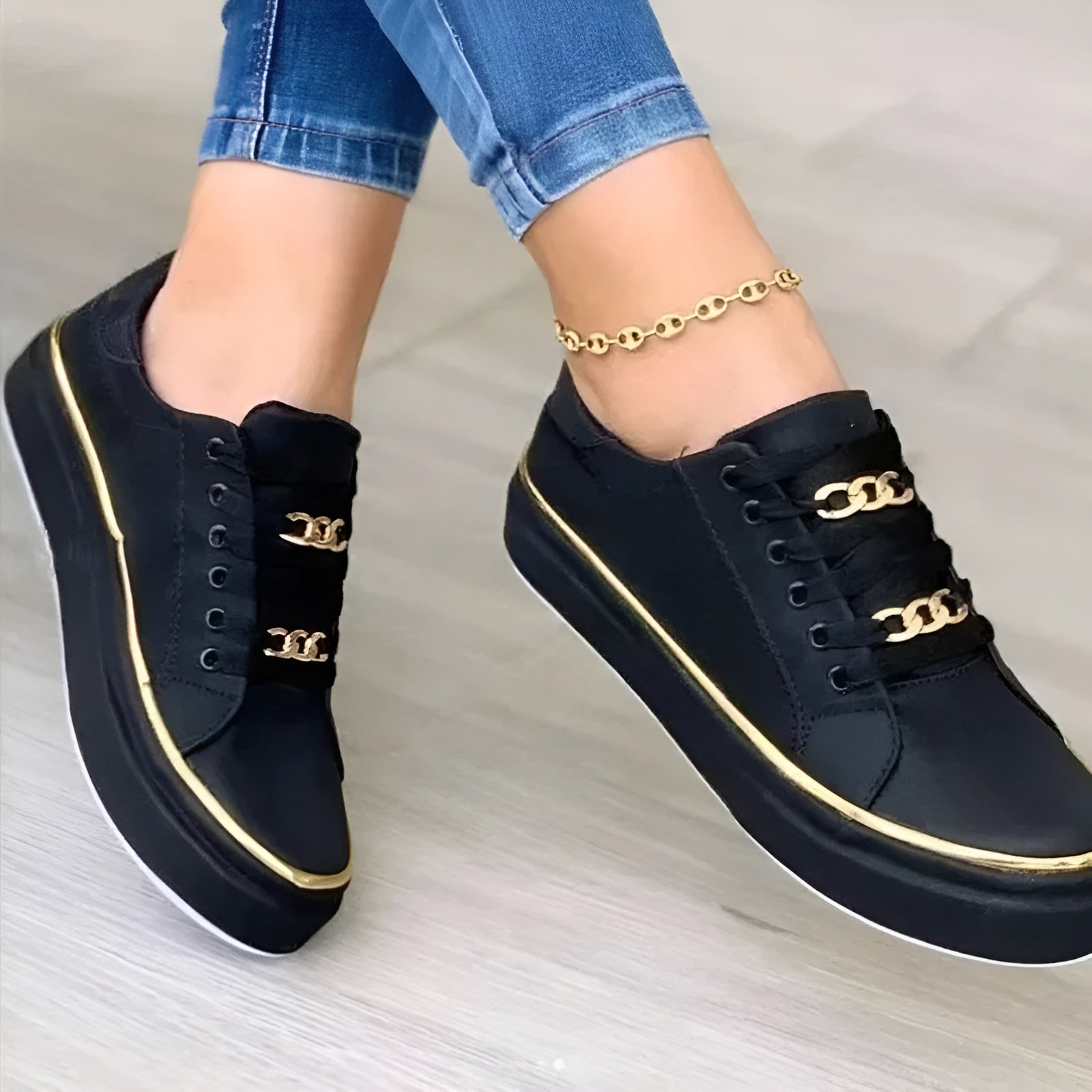 Close-up of gold chain embellishment on trainer upper