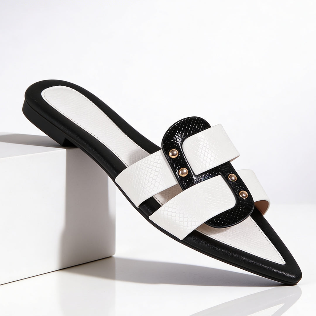 Side profile of white leather mules showing pointed toe and dual strap design