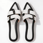 Detail shot of contrasting black strap against white leather upper