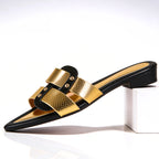 Close-up of gold-tone hardware and black snake-effect strap detail