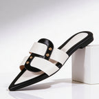 White leather pointed toe flat mules with black snake-effect straps, front view