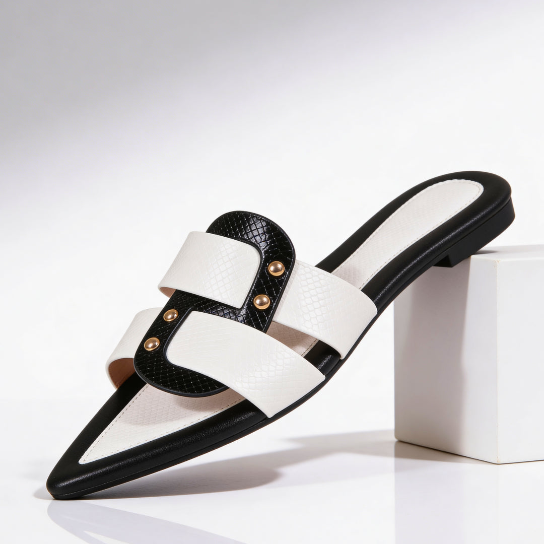 White leather pointed toe flat mules with black snake-effect straps, front view