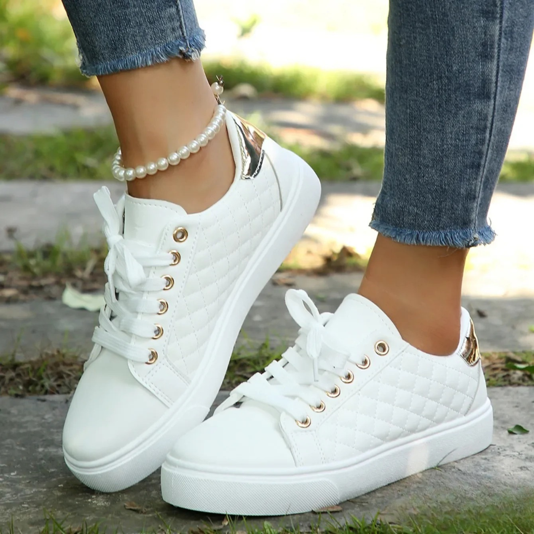 White platform trainers displayed from rear showing lace-up design