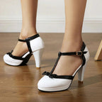 Model wearing heels, seated pose showing ankle buckle