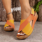 Woman walking in two-tone wedge sandals, outdoor setting