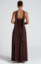 Model standing in maxi dress displaying high slit opening